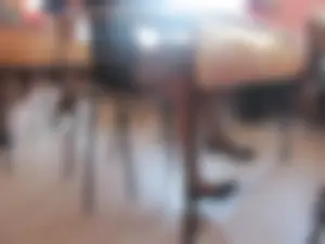Bored College Girl in a Short Dress And Flats Lying On Desk And Playing With Her Shoe in a Classroom