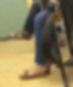 College teen's feet in flats closeup in a class