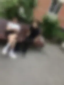 Stocky candid girl sitting on a bench on the street