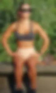 Tanned fitness woman showing off her toned physique & amazing butt