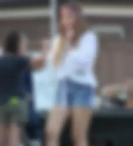 Hippie type dressed girl in denim shorts with a nice ass
