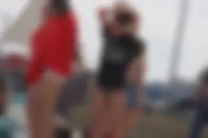 A group of teens in bikinis on the beach