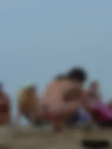 Sexy babe with a nice body topless and in a thong on the beach