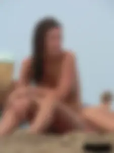 Sexy babe with a nice body topless and in a thong on the beach