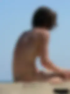 Topless beach milf looking sexy in a tiny g-string bikini