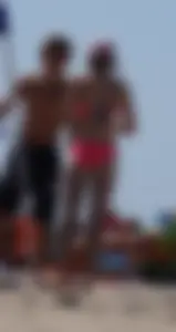 Sexy and skinny girl on the beach in pink bikini