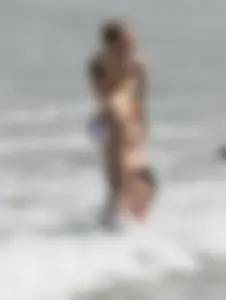 Big boobed thick blonde on the beach in a bikini