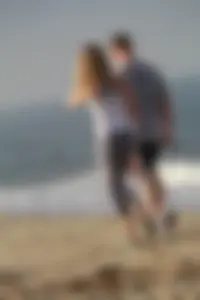 Skinny blonde on the beach in tight grey leggings