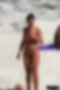 Smoking milf at a nude beach with a hairy pussy