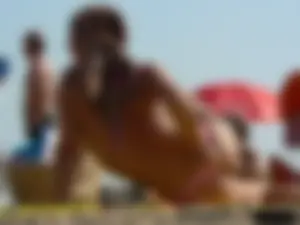 Topless tattooed lady at the beach with a nice ass in pink thong bikini