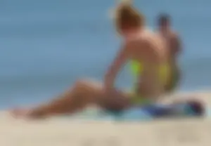 Sexy ass blonde milf on the beach in a thong with cameltoe and bending over