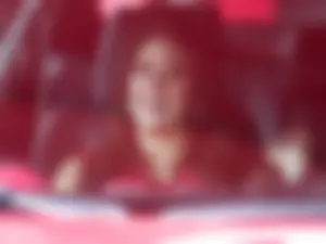 Beautiful and sexy Toyota car girl in red leggings