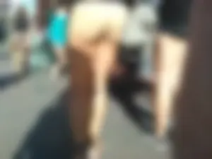 Brunette ass cheeks in short yellow shorts