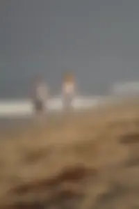 Skinny blonde on the beach in tight grey leggings