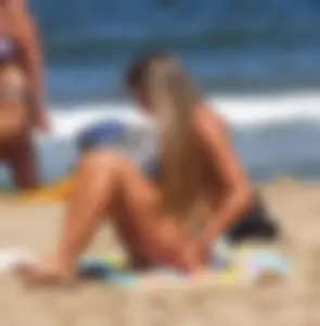 Sexy girl on the beach in a thong bikini with a nice ass