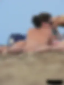 Sexy babe with a nice body topless and in a thong on the beach