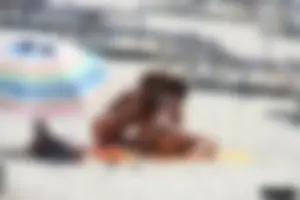 Topless milf and her topless daughter on the beach