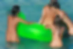 FKK Nudists playing in the water with floater