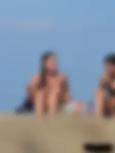 Sexy babe with a nice body topless and in a thong on the beach