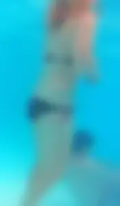 Underwater shots of a bikini teen swimming in the pool