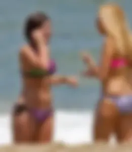 One blonde and one brunette bikini babes at the beach