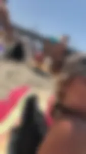 Girl in a swimsuit bending over at a beach creepshot