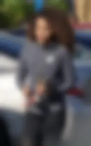 Beautiful black girl in Nike leggings in the parking lot