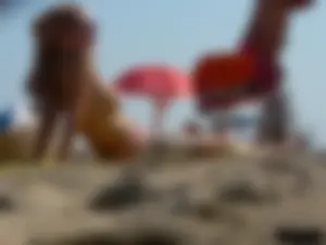 Topless tattooed lady at the beach with a nice ass in pink thong bikini