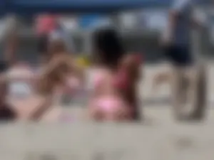 Sexy brunette on the beach in a bikini with great tits