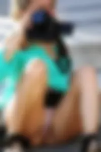 Blonde lady upskirted showing her panties and pussy lips