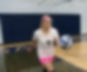 Bunch of cute college girls in bright pink shorts playing volleyball