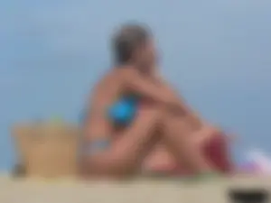 Sexy lady on the beach in a blue thong bikini