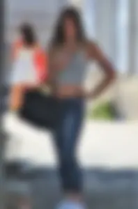 Sexy blonde girl in tight jeans and showing midriff