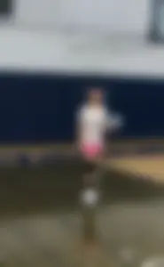 Bunch of cute college girls in bright pink shorts playing volleyball