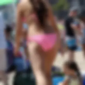 Sexy brunette on the beach in a bikini with great tits
