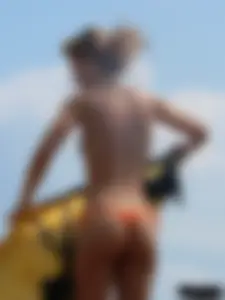 Two topless friends on the beach with nice boobs