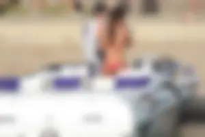 Brunette on a boat in red thong bikini with a tight little ass