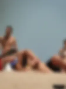 Topless lady on the beach in a gold thong with a nice ass