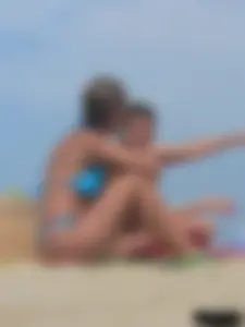 Sexy lady on the beach in a blue thong bikini