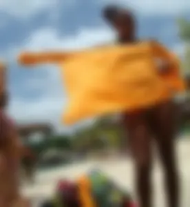 Sexy black babe in various bikinis on the beach while on vacation