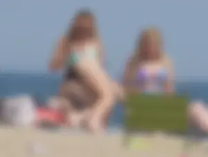 3 girls on the beach in bikinis with big boobs, one brunette and two blondes
