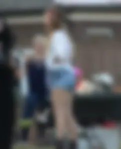 Hippie type dressed girl in denim shorts with a nice ass