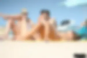 2 topless girls at the beach in thongs