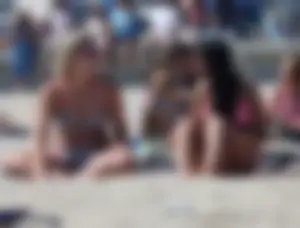Sexy brunette on the beach in a bikini with great tits