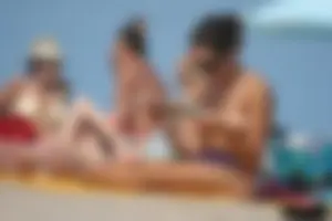 2 topless girls at the beach in thongs