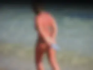 Blonde milf on the beach in her bikini