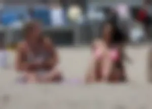 Sexy brunette on the beach in a bikini with great tits