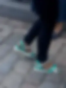 Teen feet in sandals and pantyhose on the street closeup photos