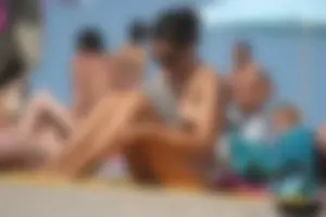 2 topless girls at the beach in thongs