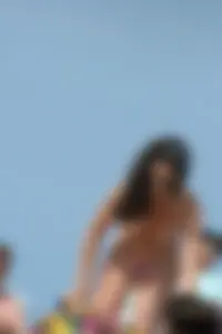 2 topless girls at the beach in thongs